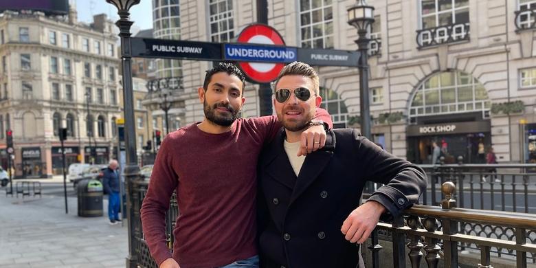 Deux personnes debout devant une gare à Londres