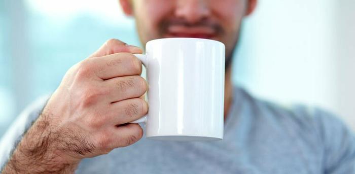 person drinking out of mug