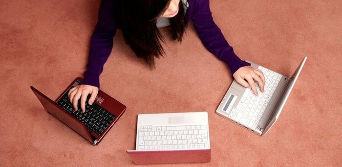 person with three computers