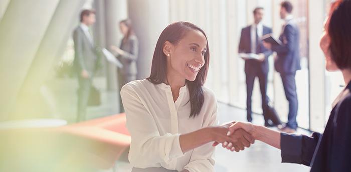 two colleagues shaking hands at work