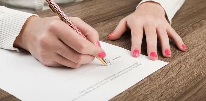 person preparing to sign a contract
