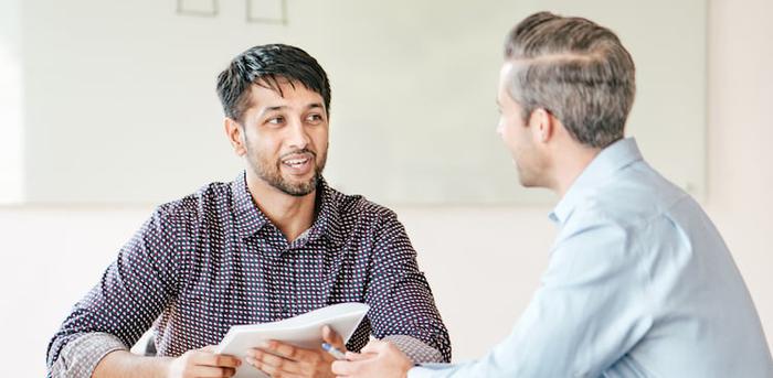 two people talking at a table