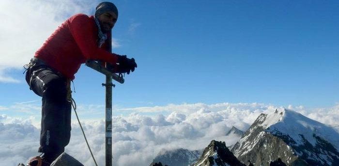 Photo of man climbing a mountain