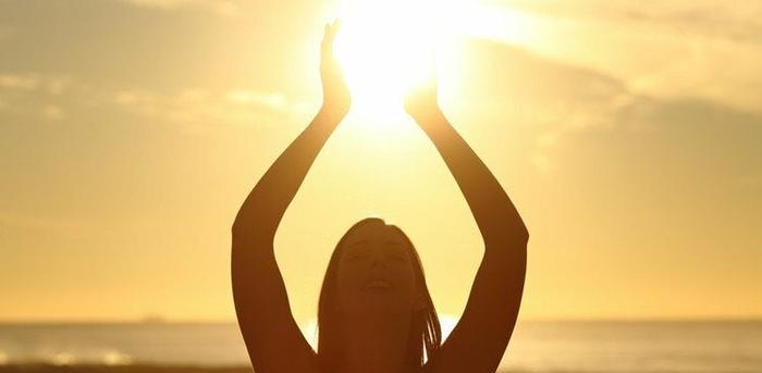 woman holding sun