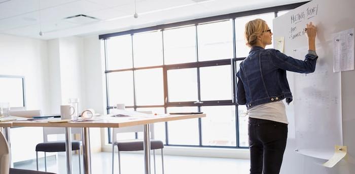 person writing in meeting