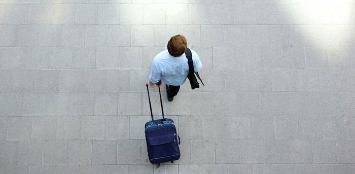 person walking with suitcase