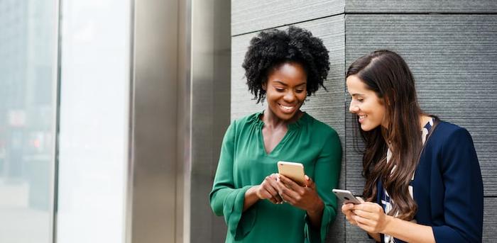 coworkers looking at their smartphones