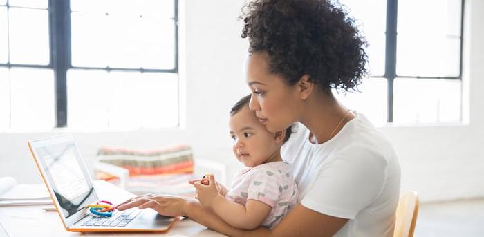 parent with baby at computer