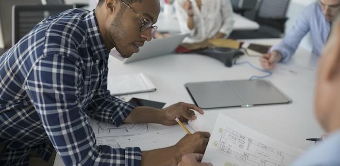 person writing in meeting