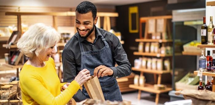 salesperson assisting customer in small store