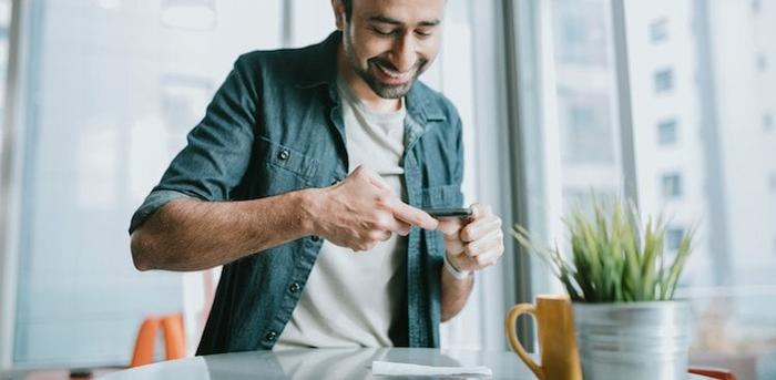 person taking picture of paycheck