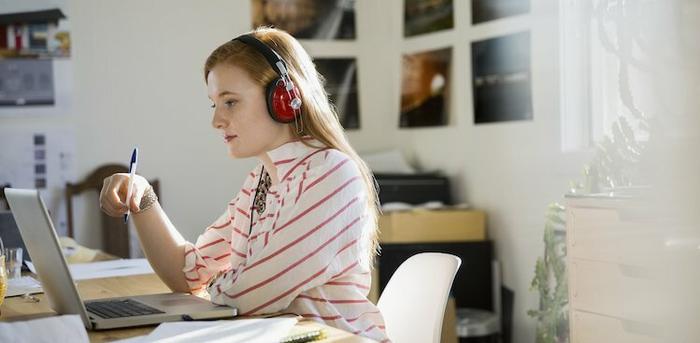 person on laptop with headphones