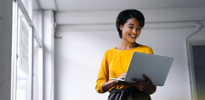 smiling person on laptop