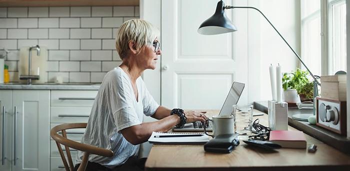 person using laptop at home office