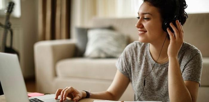 person sitting on floor with laptop on coffee table