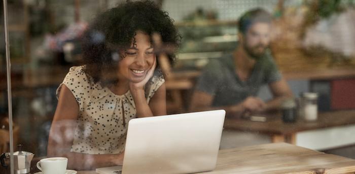 person at coffeeshop sitting with a computer courtesy pixdeluxe/Getty Images