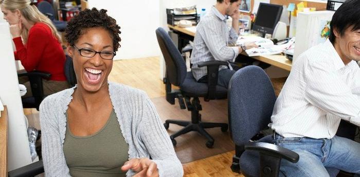 co-workers laughing courtesy Christopher Robbins/Getty Images