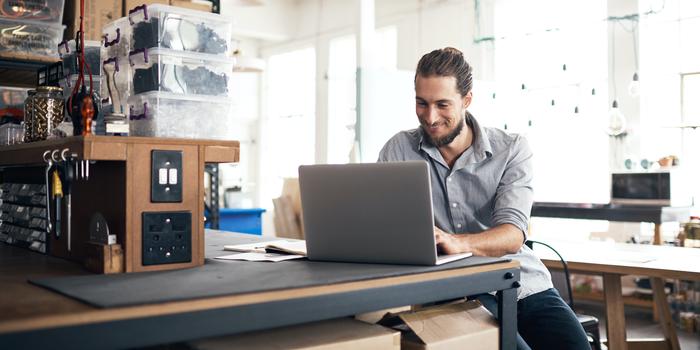 person sending email on laptop at table