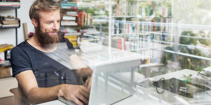 person at desk on laptop