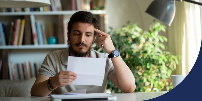 person reading a document with a serious face