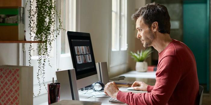 person sitting at a desk in a video meeting