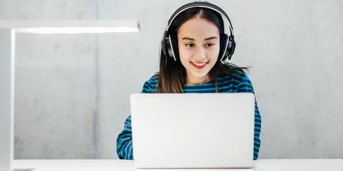 person working on a laptop with headphones on