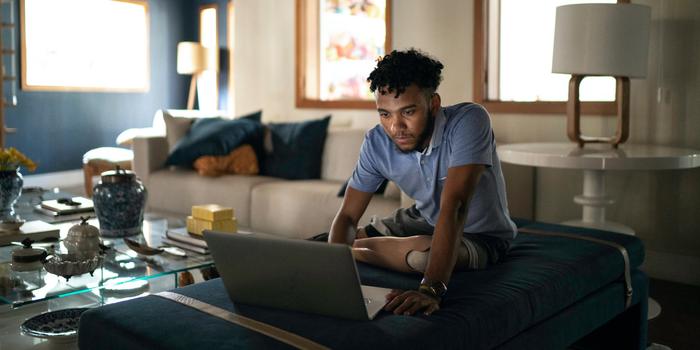 person in living room on laptop