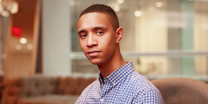 a person in a checkered button-down shirt.