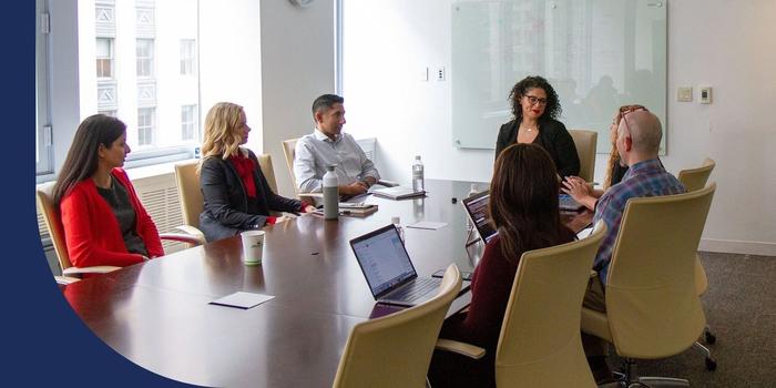 Healthfirst employees having a meeting in a conference room.