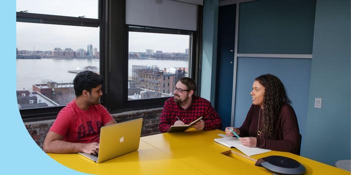 Three Integral Ad Science employees meeting in a conference room.