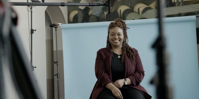 smiling person sitting in a video shoot set