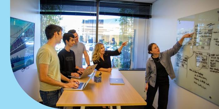 Oscar Health employees brainstorming ideas with a whiteboard