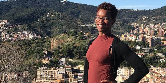 smiling person standing on a scenic viewpoint