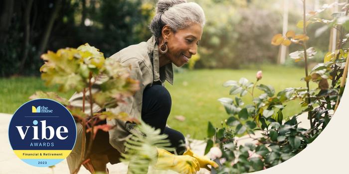 An older woman smiling as she gardens in her backyard.