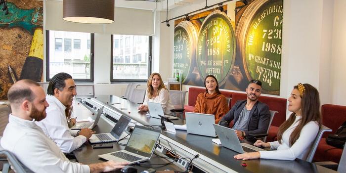 People sitting around a long conference room table.