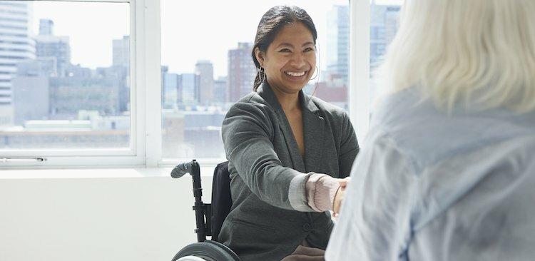 person with a disability shaking hands with a colleague