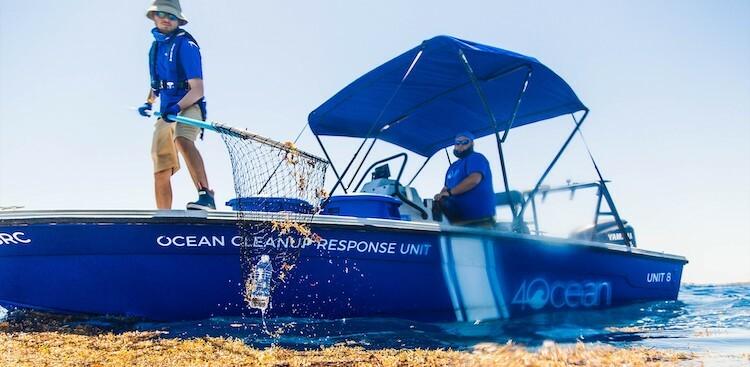 4Ocean employees cleaning up plastic in the ocean