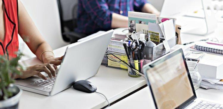people on laptops in modern office