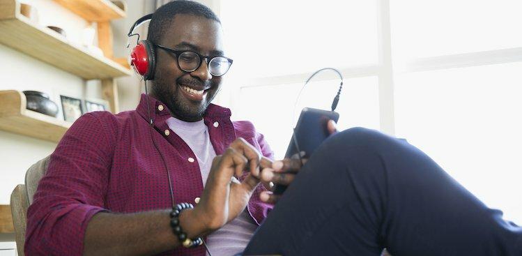 person listening to podcasts courtesy Hero Images/Getty Images