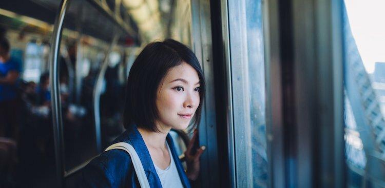 female looking out of window on subway