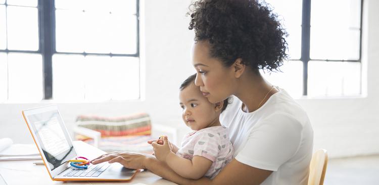 parent with baby at computer