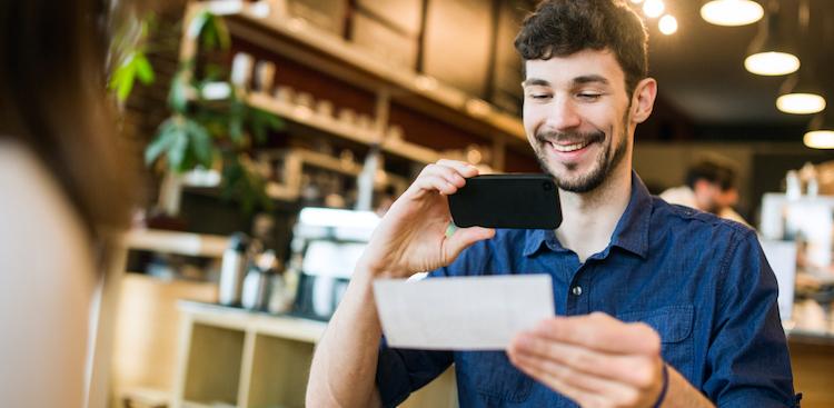 What Is Bonus Pay, bonuses. person taking a picture of their paycheck