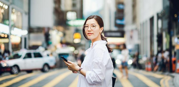person using phone on a city street