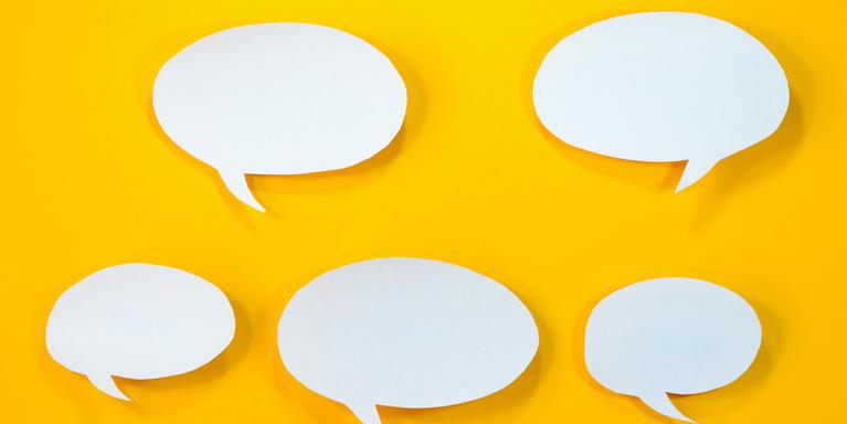 white speech bubbles cut out of paper against a bright yellow background