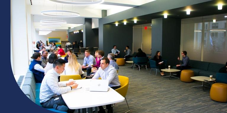 people sitting in various tables and booths inside an office