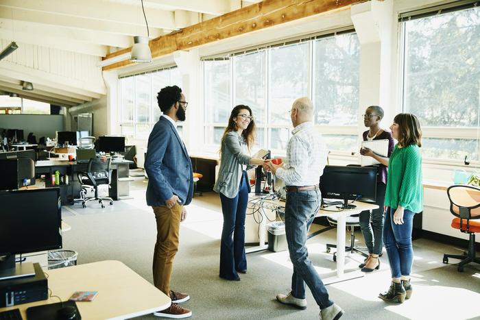 group of people standing in a modern office