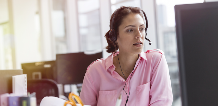 person sitting at a desk with a headset