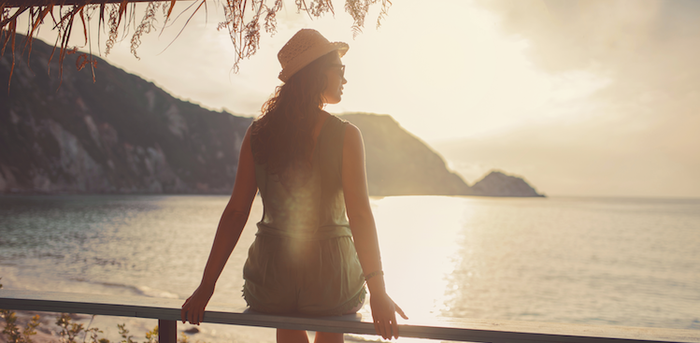 person sitting looking out on a body of water