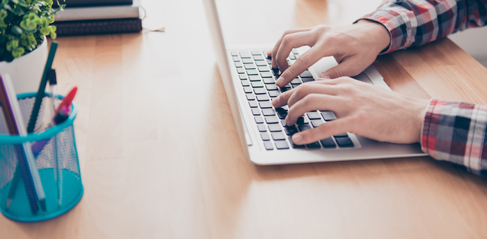 person typing on a laptop