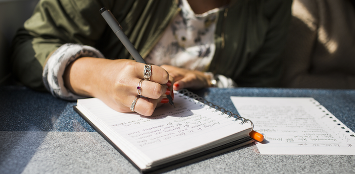 person writing in a notebook